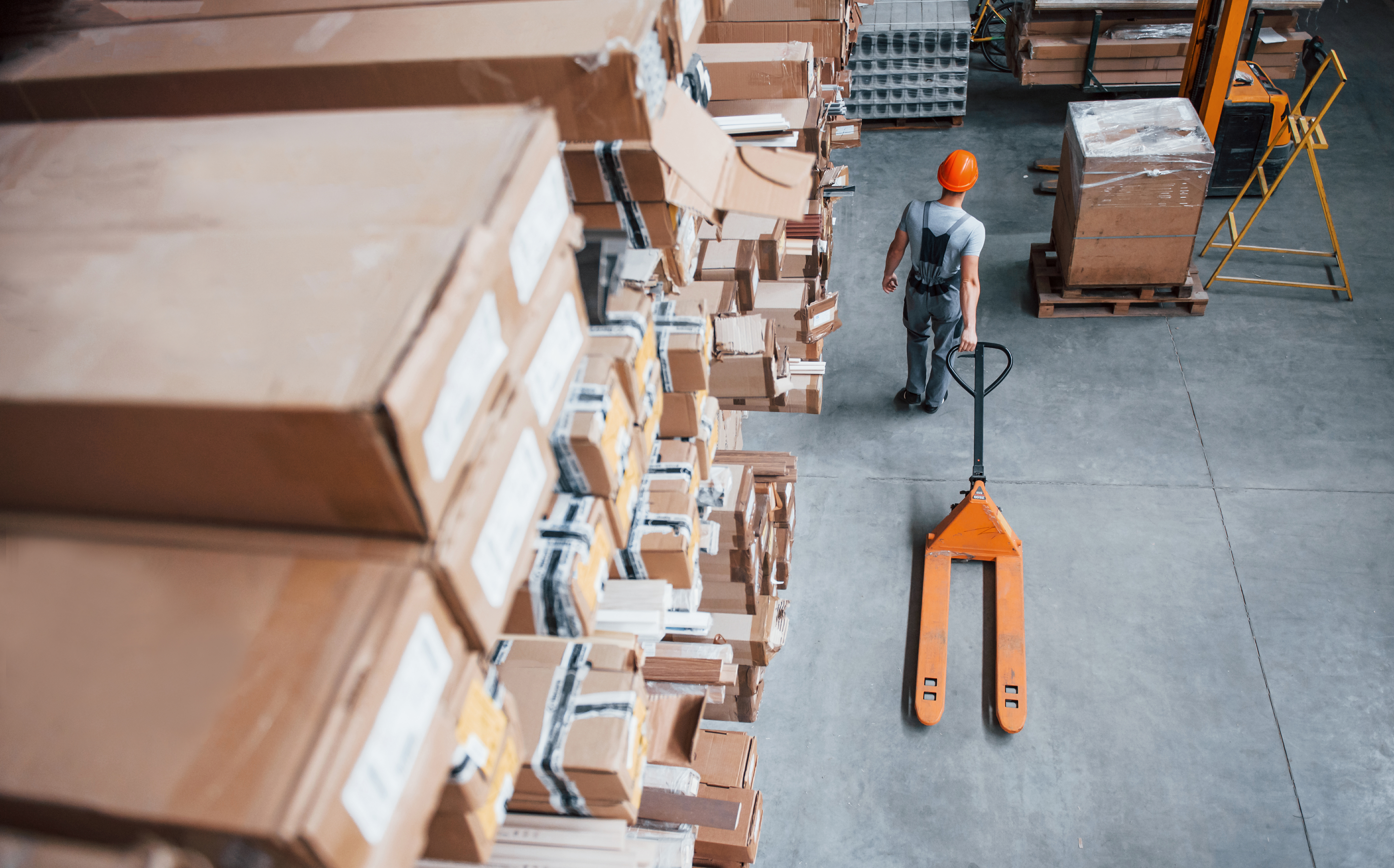 top-view-of-male-worker-in-warehouse-with-pallet-t-2023-11-27-04-52-07-utc